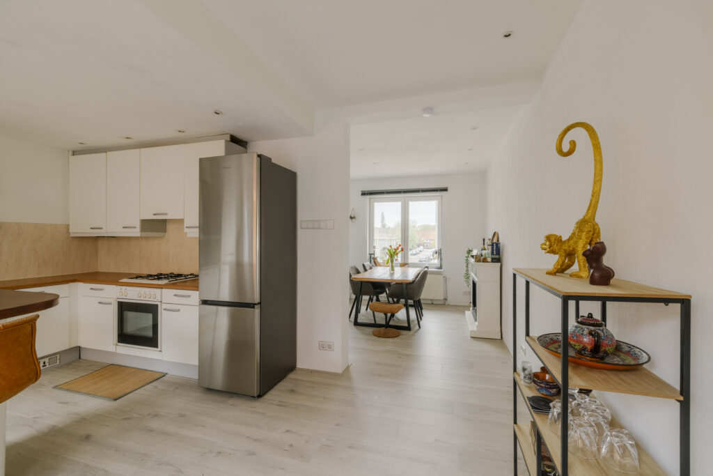 Modern kitchen and dining area with large window view.