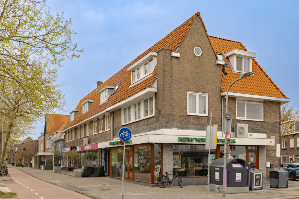 Corner building with shops and bike lane.