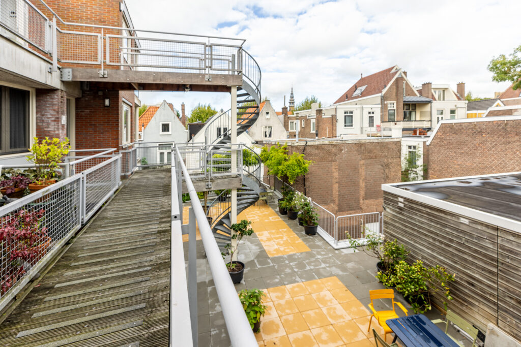 Urban rooftop terrace with spiral staircase