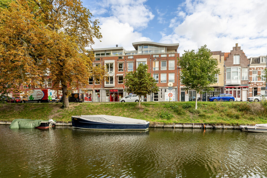 Canal with boats and buildings in the background.