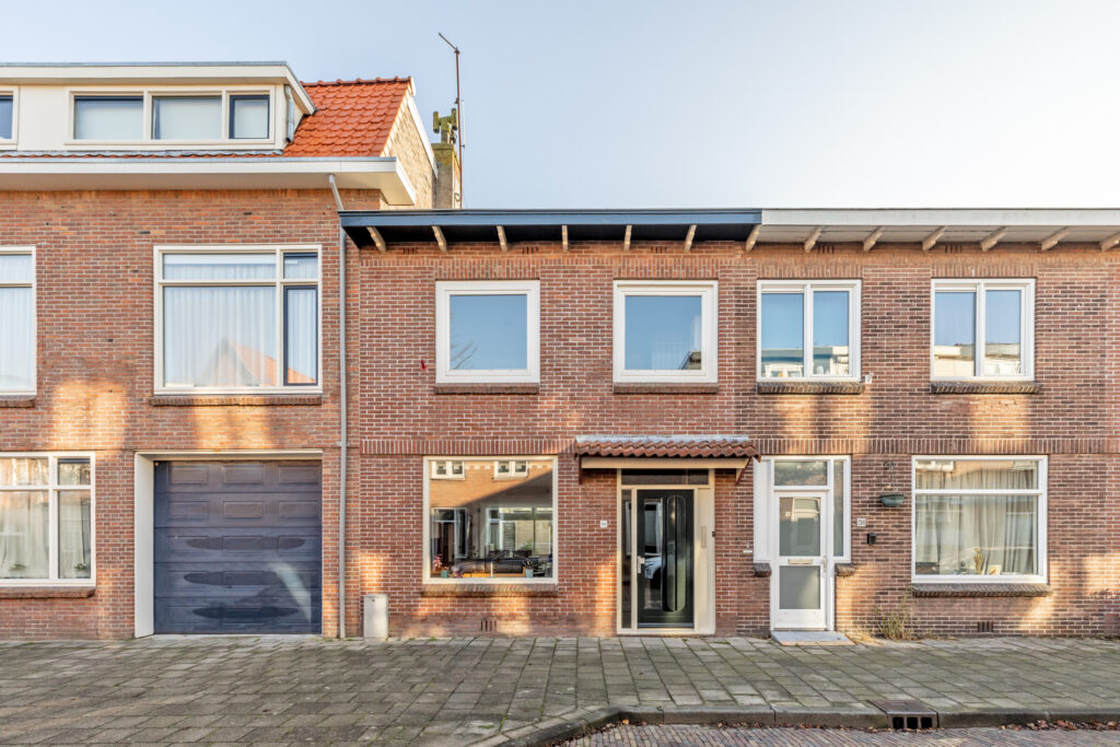Brick residential house with windows and garage door.