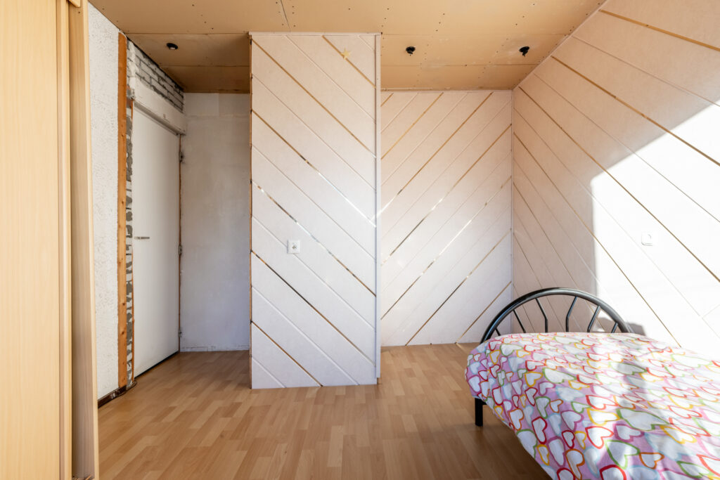 Minimalist room with bed and patterned decor.