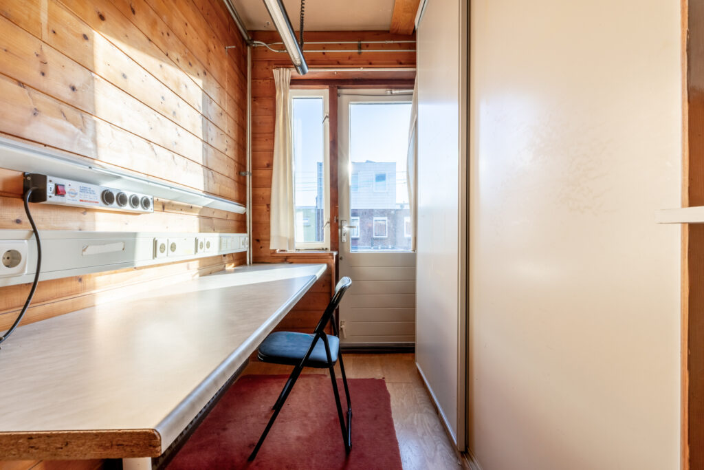 Small wooden office with desk and chair