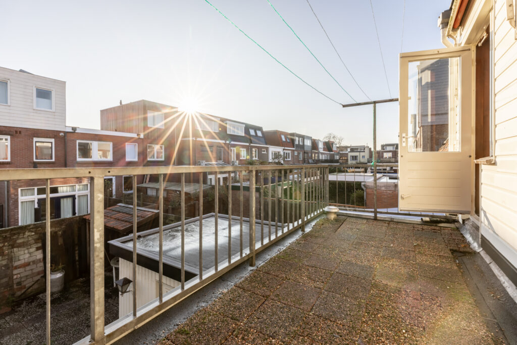 Sunny terrace overlooking residential neighborhood.
