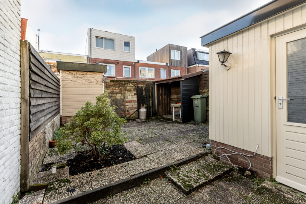 Residential backyard with small patio and garden shed.