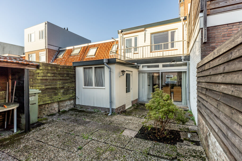 Small backyard with paved patio and plants.