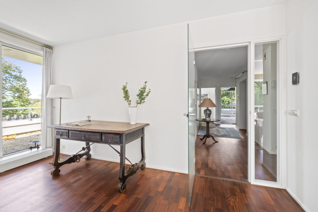 Bright room with desk and large window view.