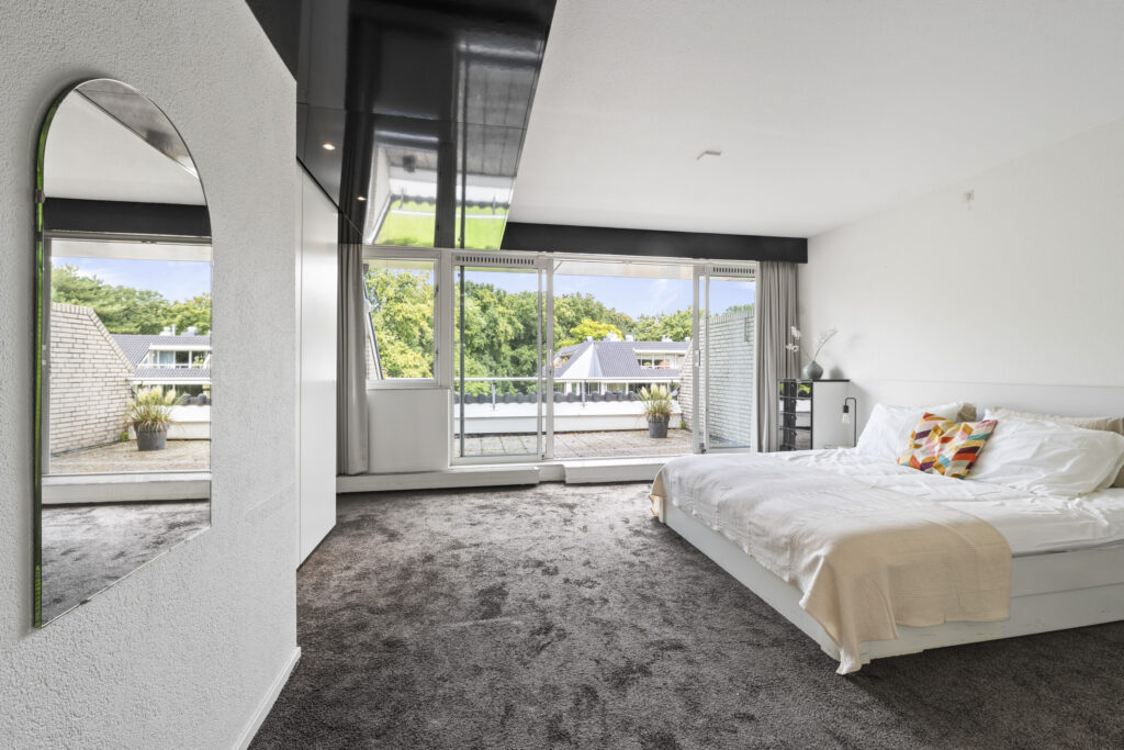 Bright bedroom with balcony and modern decor.