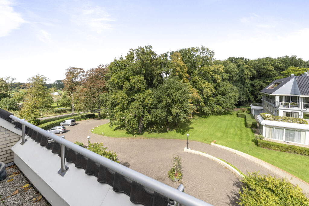 Scenic view of garden, trees, and building exterior.
