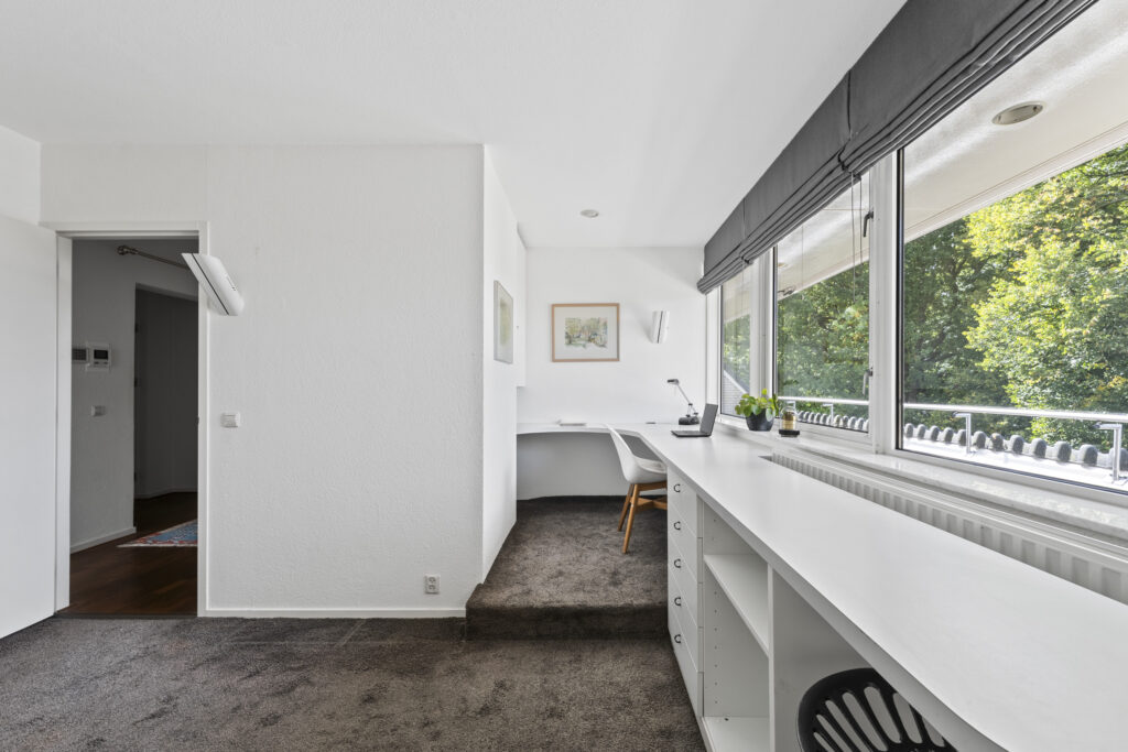 Bright home office with large window and desk