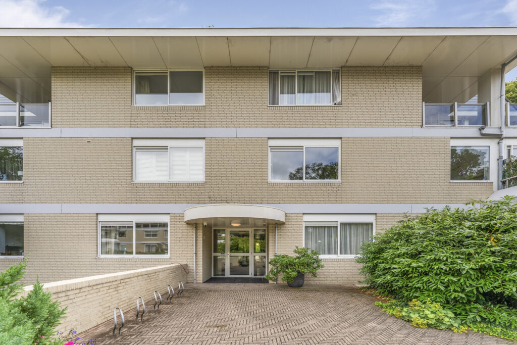 Exterior view of modern beige apartment building.