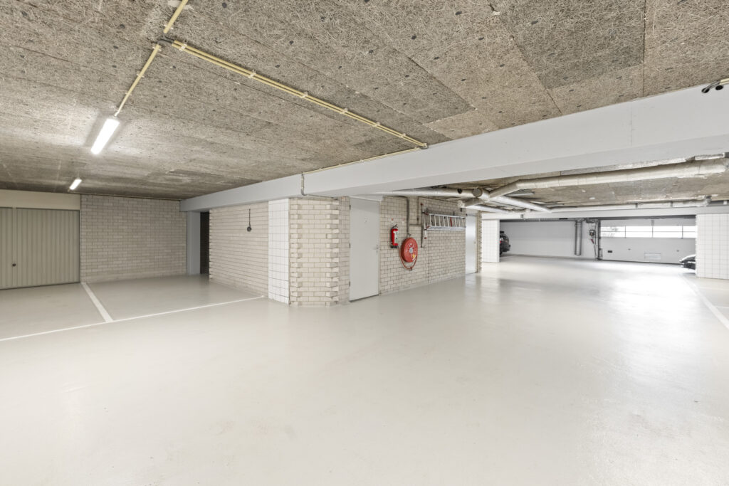 Empty underground parking garage with painted walls.