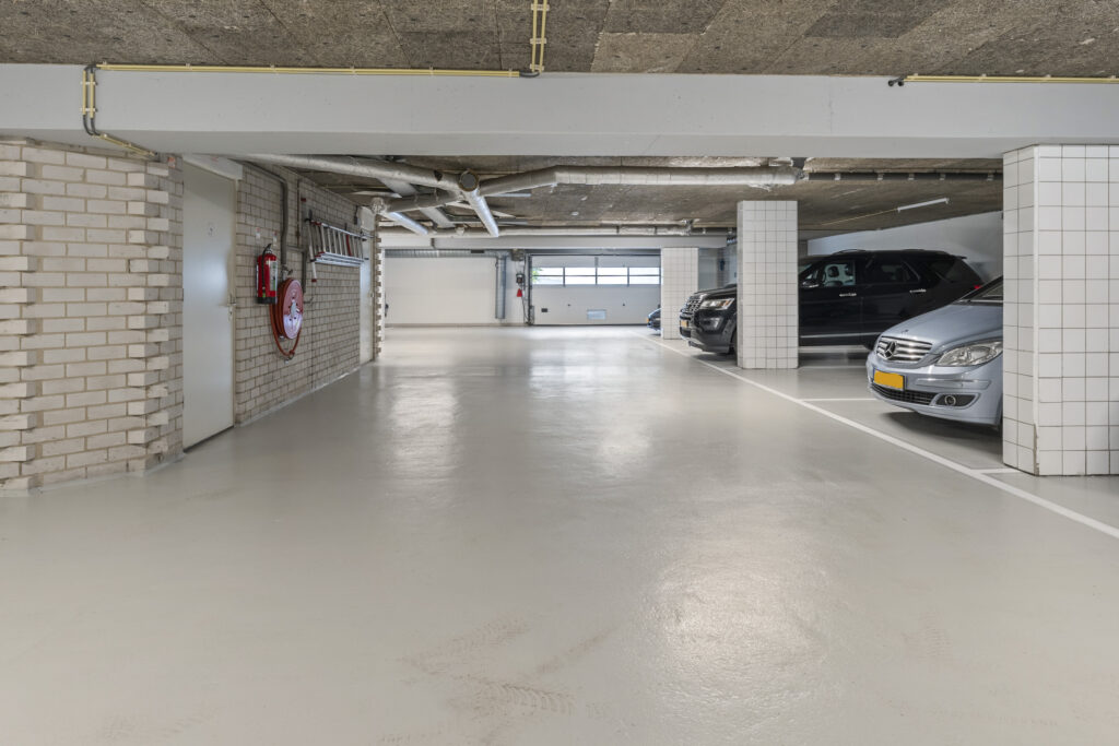 Underground parking garage with parked cars.
