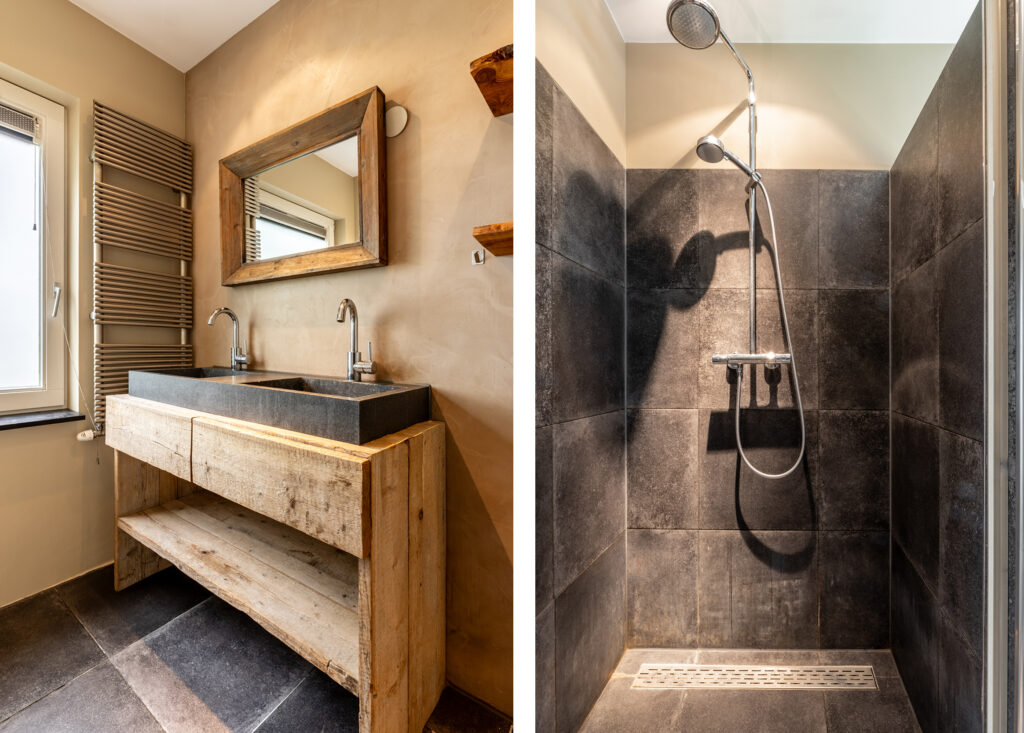 Modern bathroom with double sink and tiled shower.