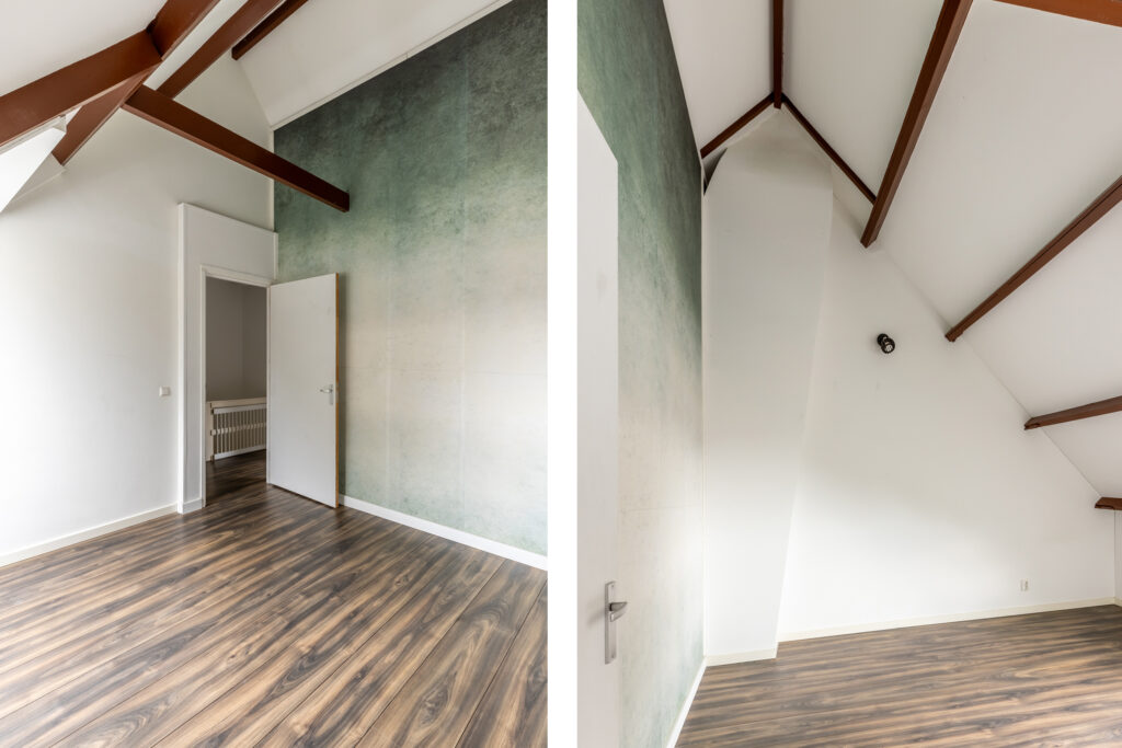 Empty room with wooden floor and green wall.