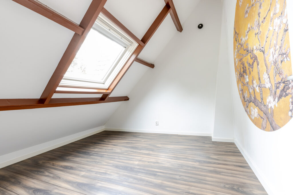 Loft room with skylight and floral mural