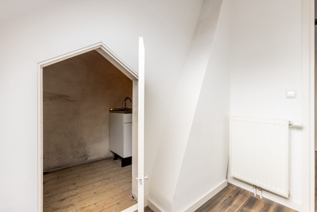 Small room with sink and narrow doorway