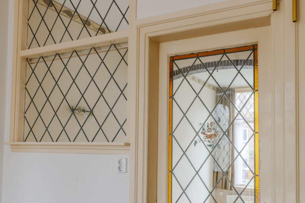 Decorative stained glass window with diamond pattern.