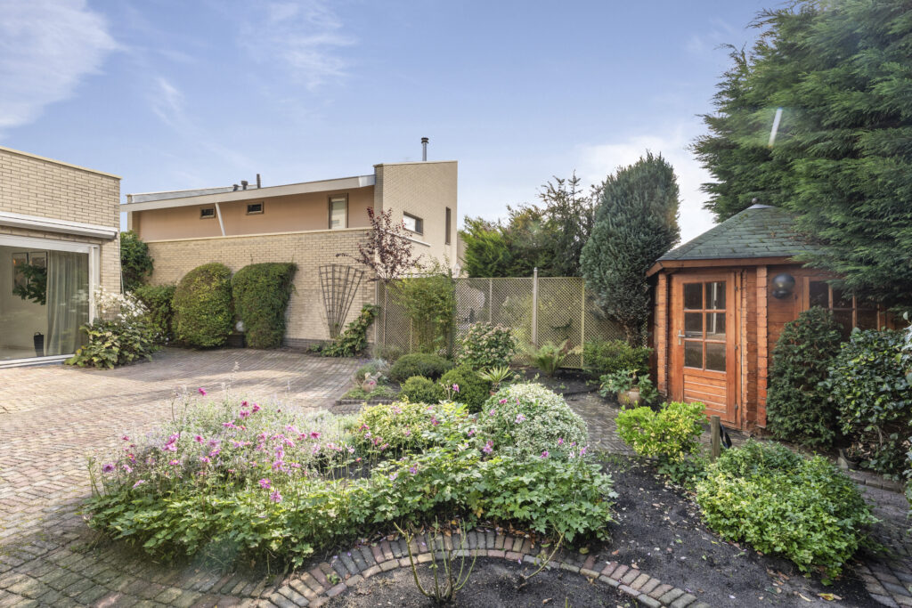 Cozy backyard with garden and wooden gazebo.