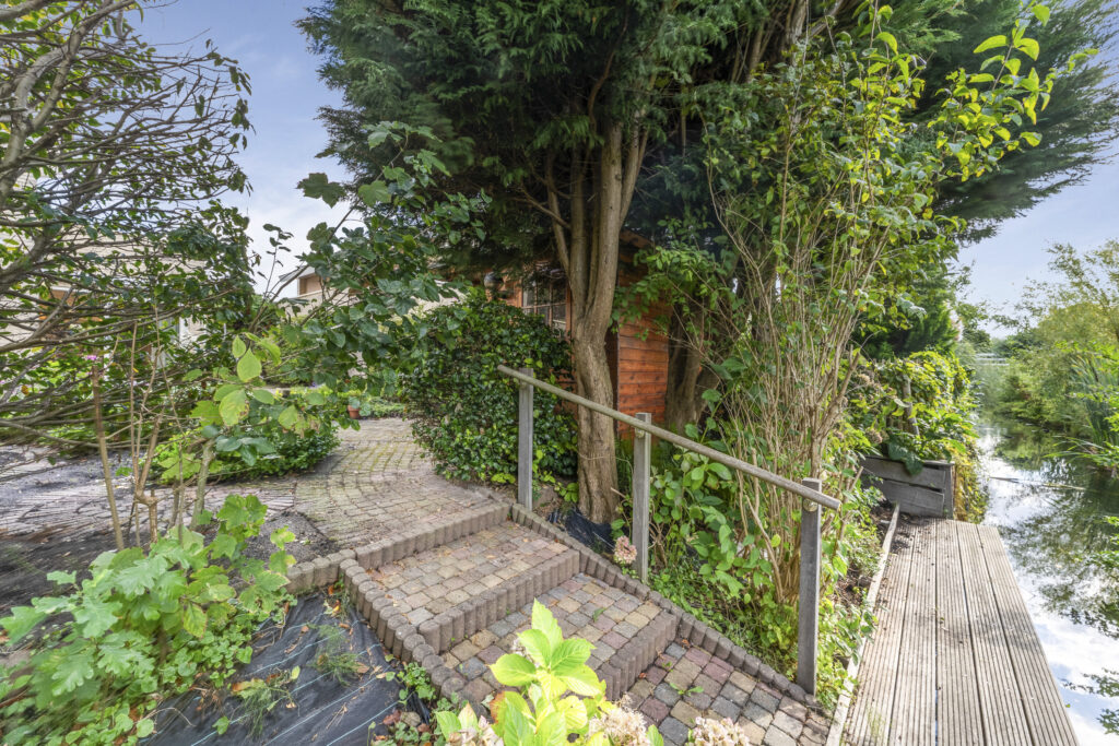 Garden path with trees and wooden railing