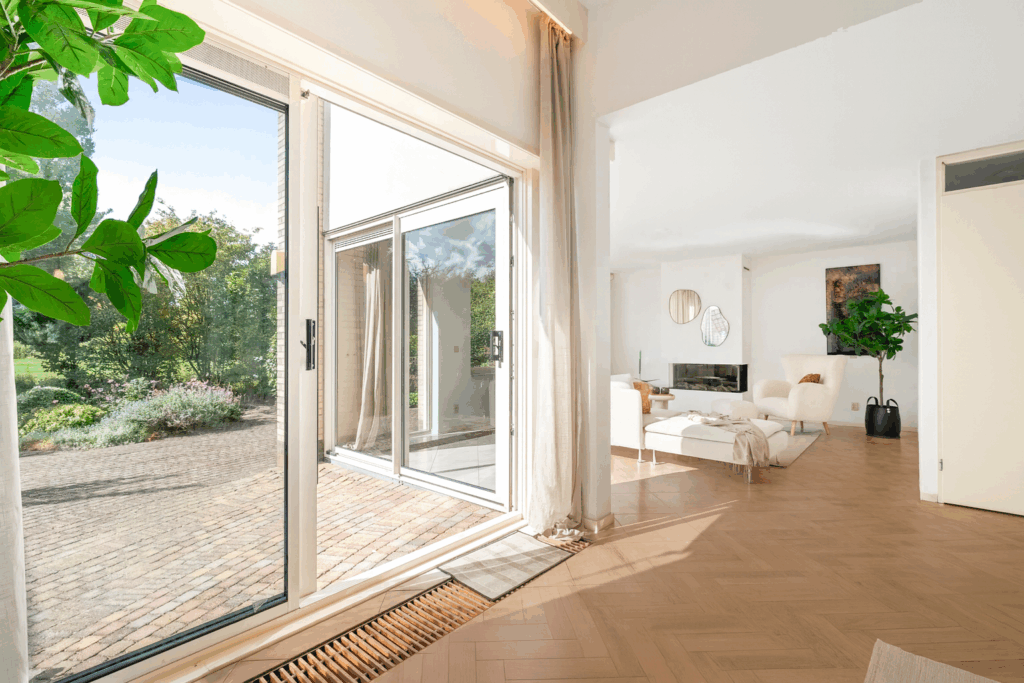 Bright living room with garden view through glass doors