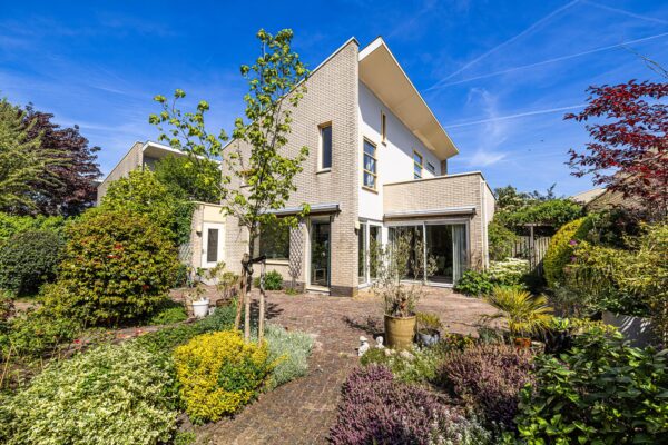 Modern house with lush garden and blue sky