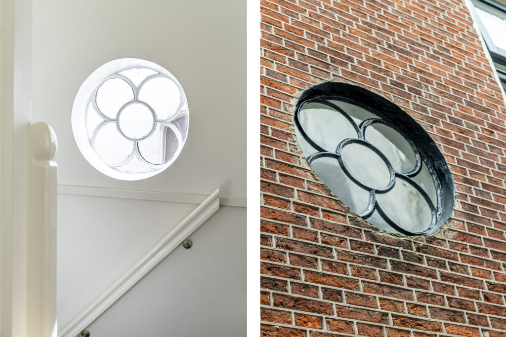 Round flower window in brick and white walls.