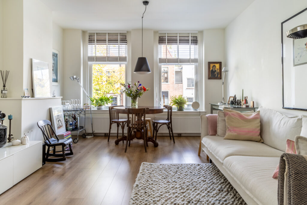 Cozy living room with modern decor and large windows.