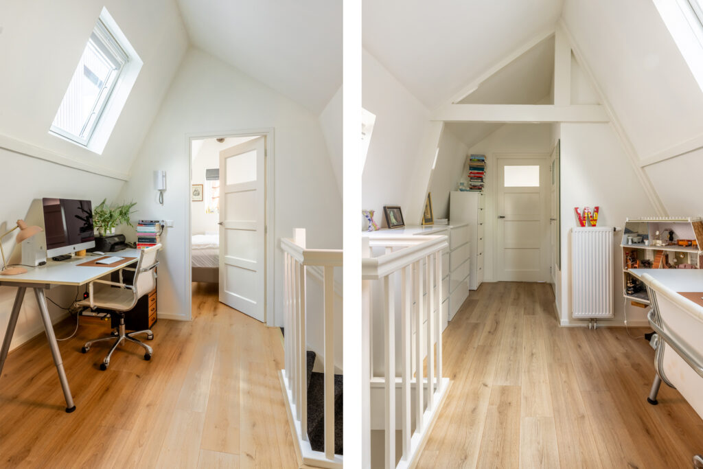 Cozy attic workspace with computer and books.