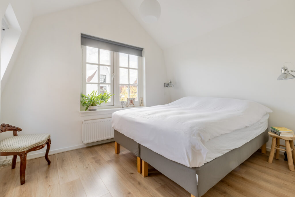 Bright bedroom with large bed and window