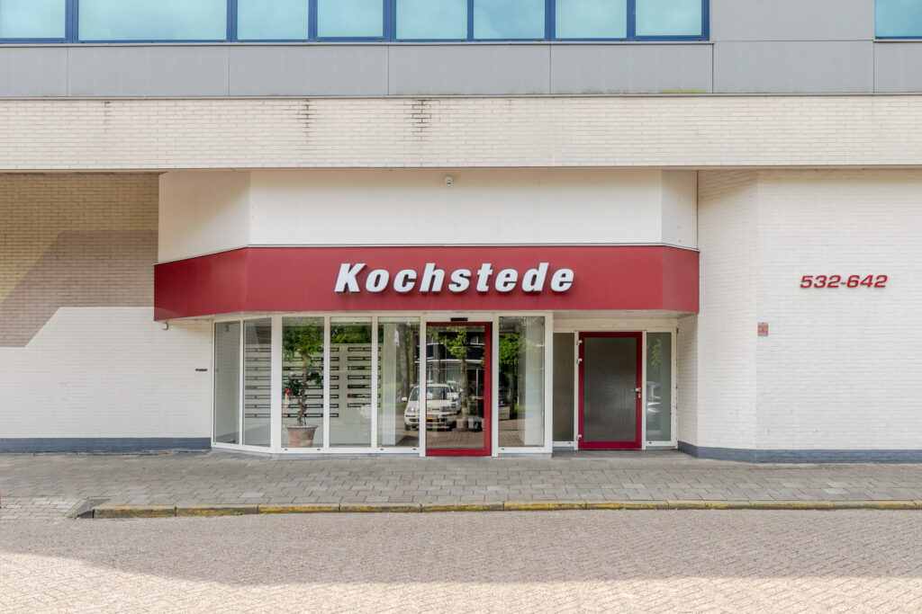 Storefront with Kochstede sign and address number.