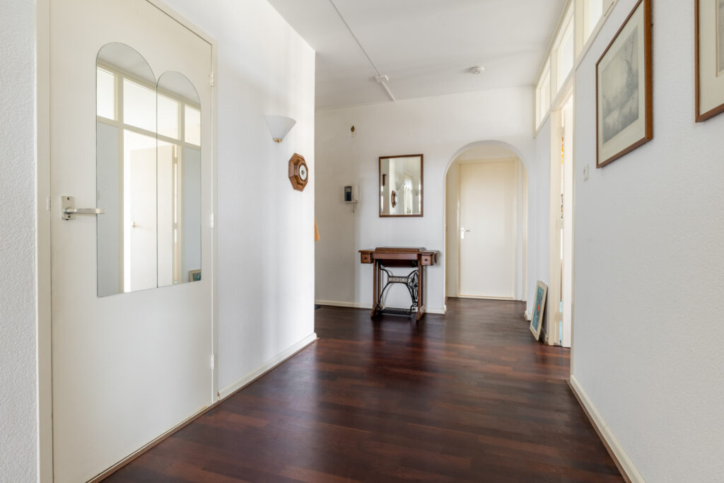 Vintage hallway with sewing table and mirror.