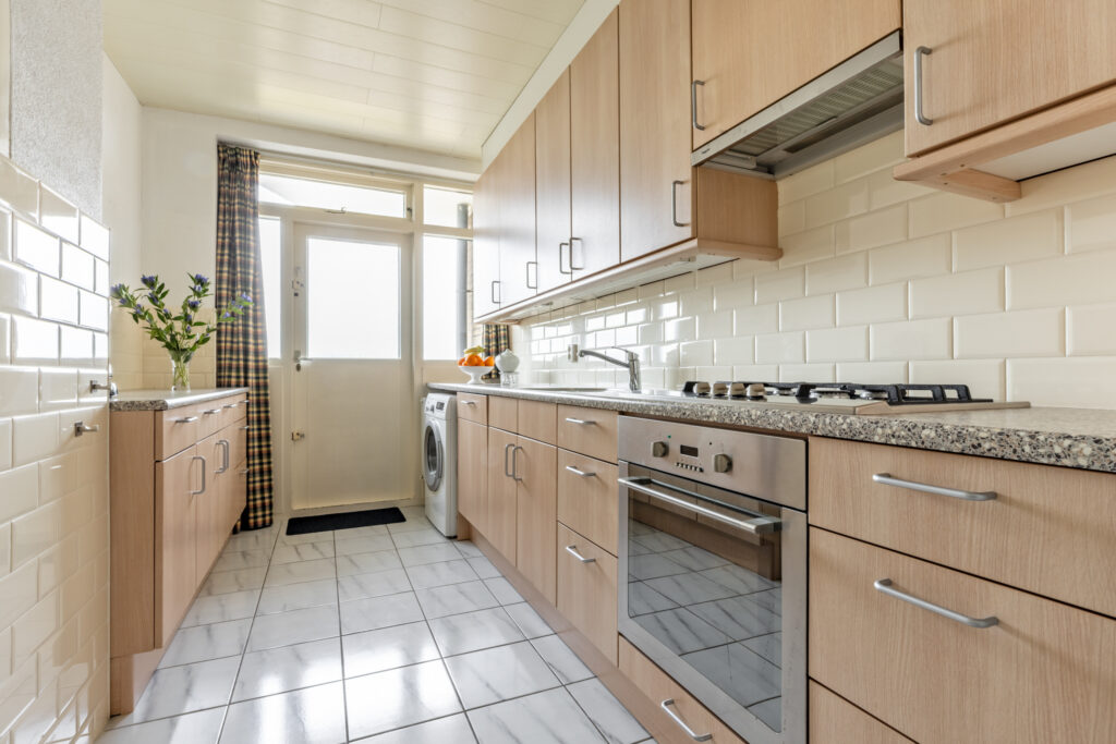 Modern kitchen with wooden cabinets and appliances.