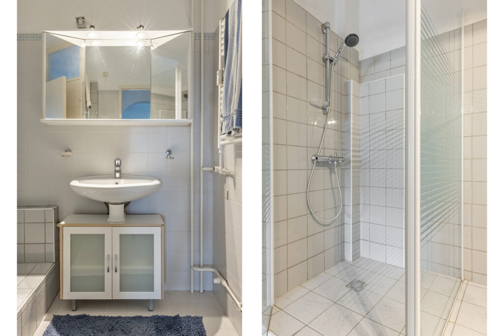 Modern bathroom with sink and walk-in shower.