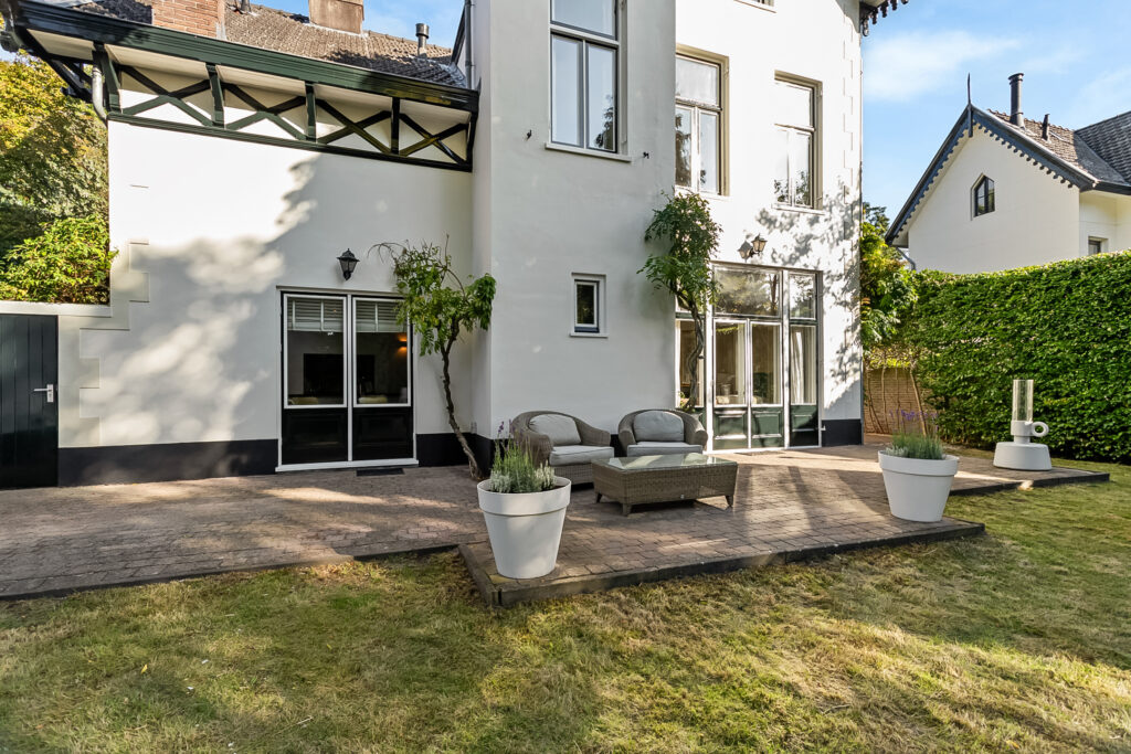 Elegant patio with outdoor seating and potted plants.