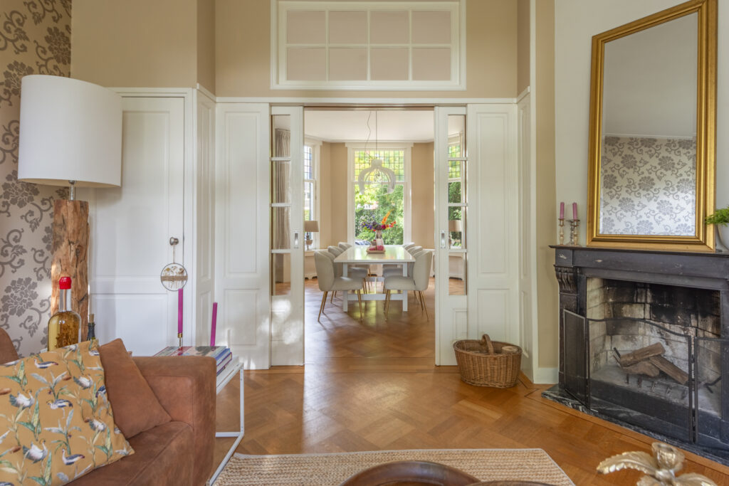 Elegant living room with wooden floors and fireplace.