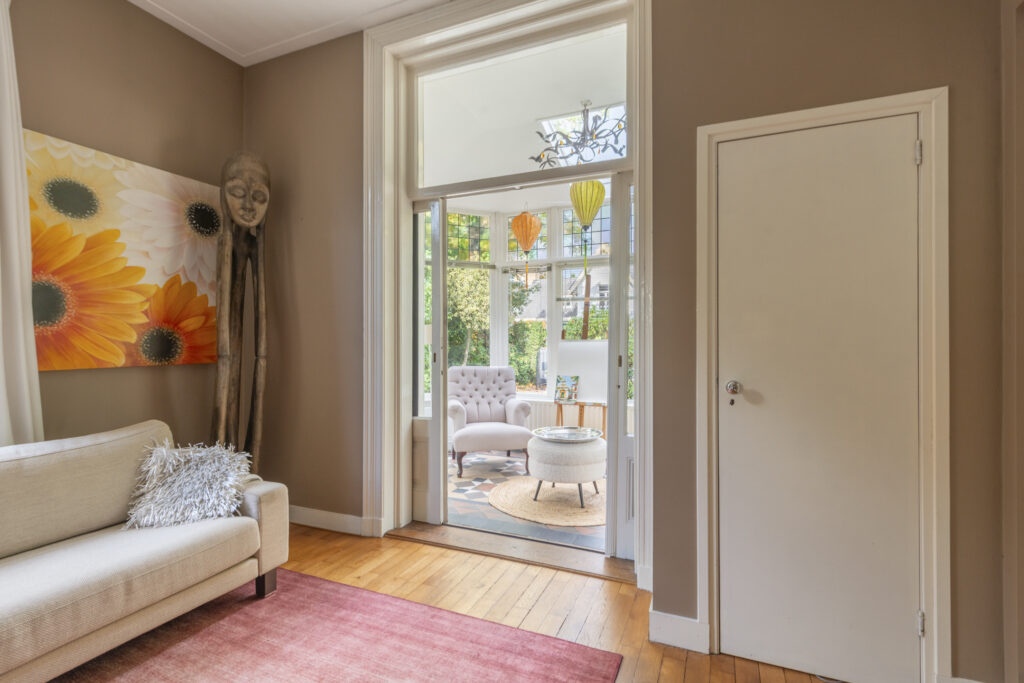 Cozy living room with large windows and decor.