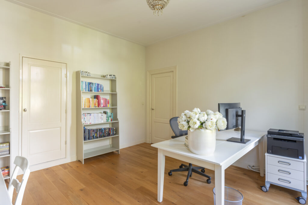 Bright home office with bookshelves and flowers