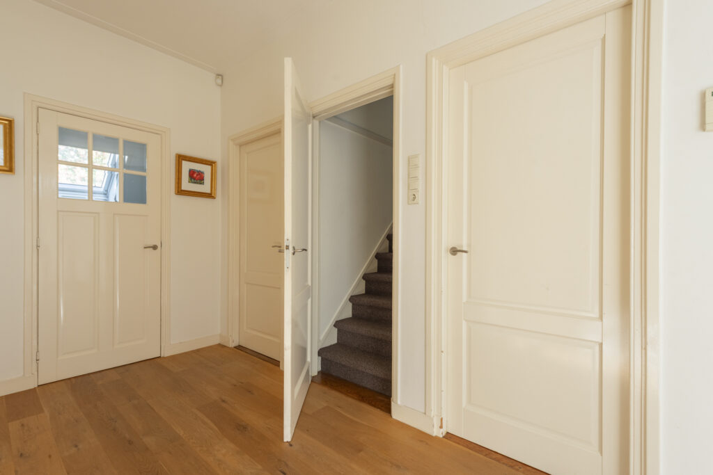 Interior hallway with doors and staircase.