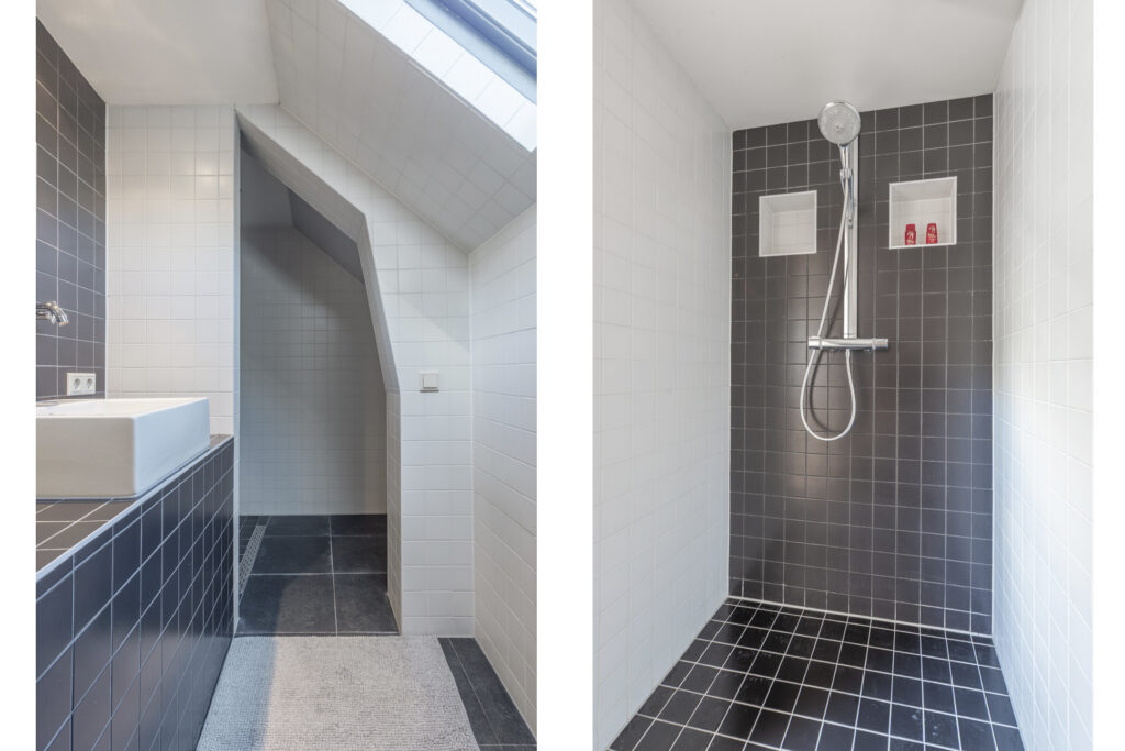 Modern bathroom with tiled shower and sink.