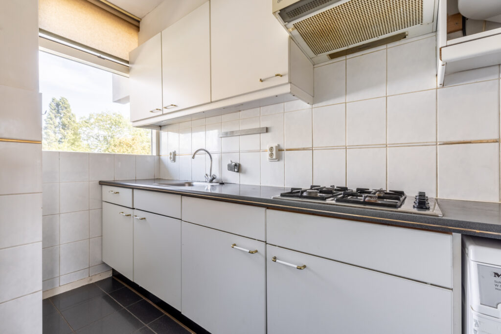 Modern kitchen with stove and cabinets.