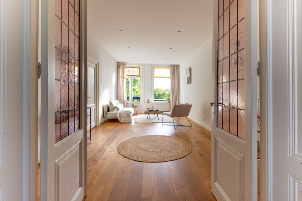 Bright living room with wooden floors and furniture.