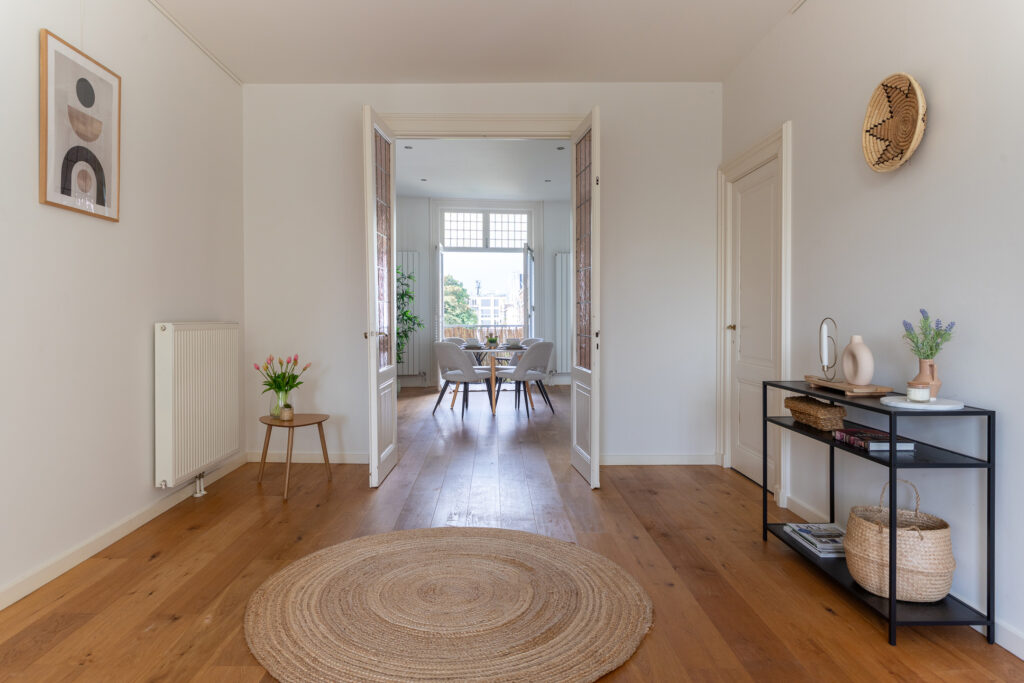 Spacious living room with wooden floors and decor.