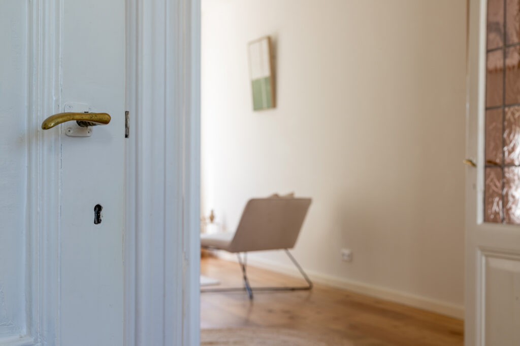 Open door to a bright, modern room