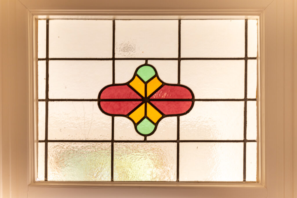 Colorful stained glass window design with geometric patterns.