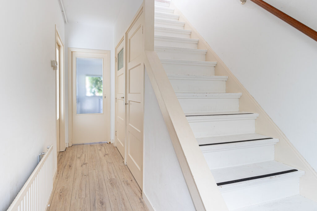 White staircase in modern home hallway