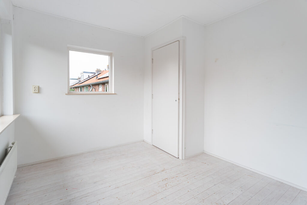 Empty room with white walls and wooden floor