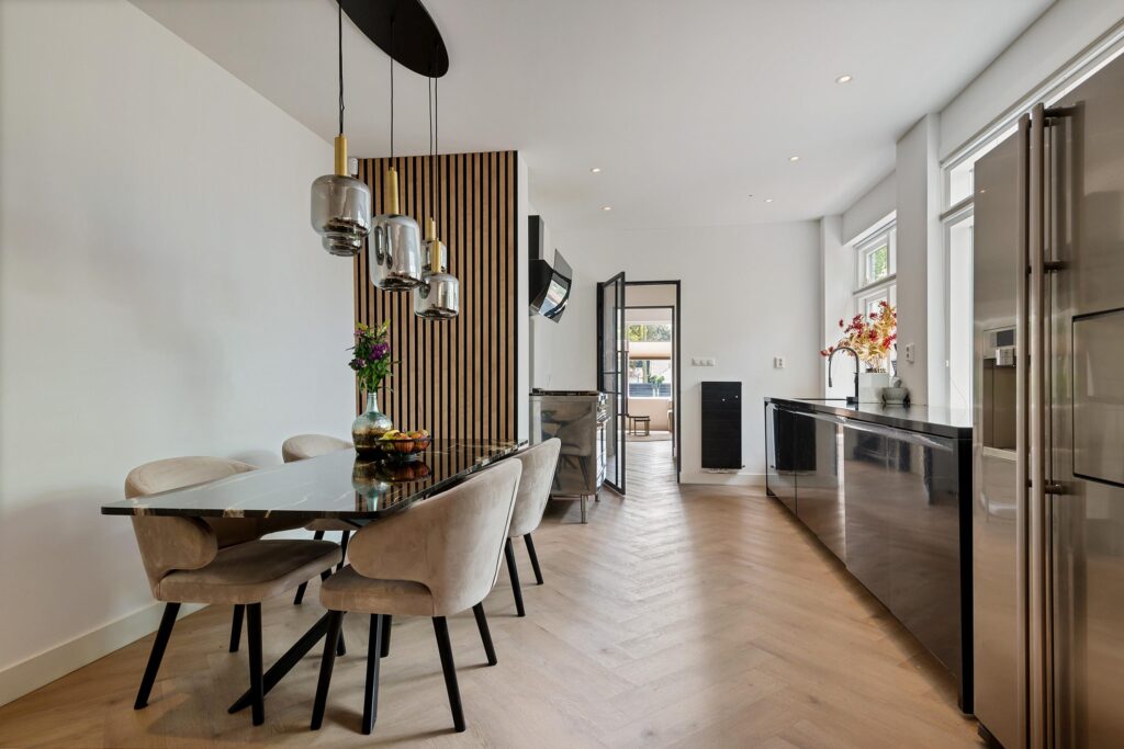Modern dining room with elegant decor and lighting.