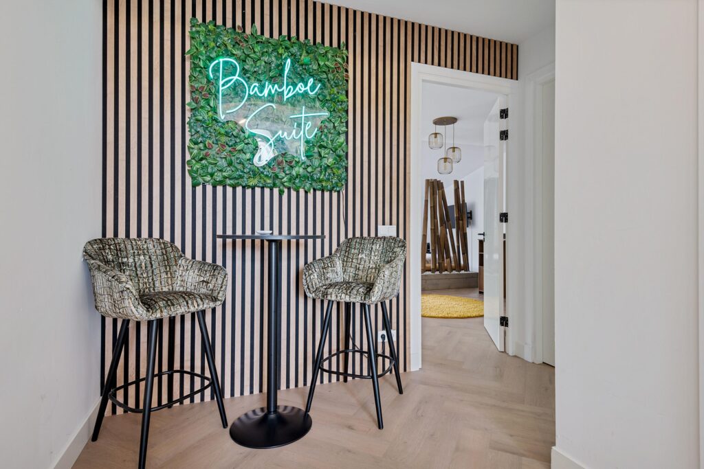 Bamboo Suite sign with bar stools and table.