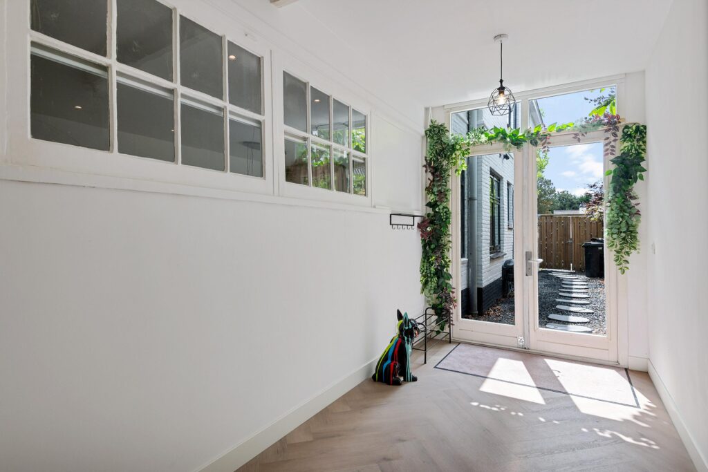 Bright hallway leading to garden with glass door